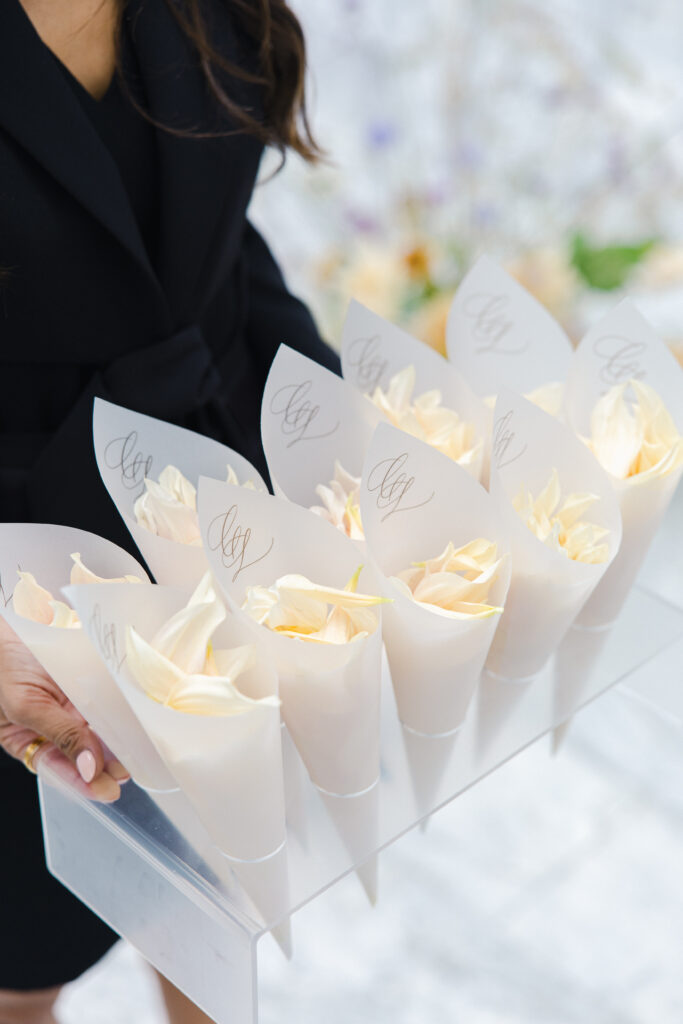 Custom calligraphy monogram on vellum petal toss cones.