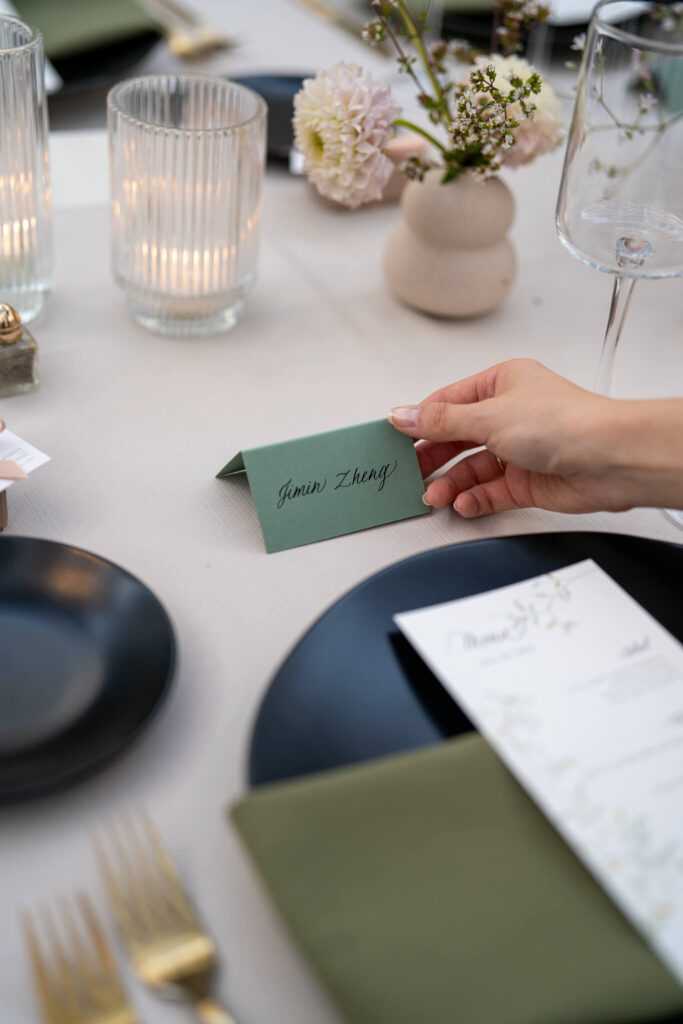 Setting down calligraphy place cards.