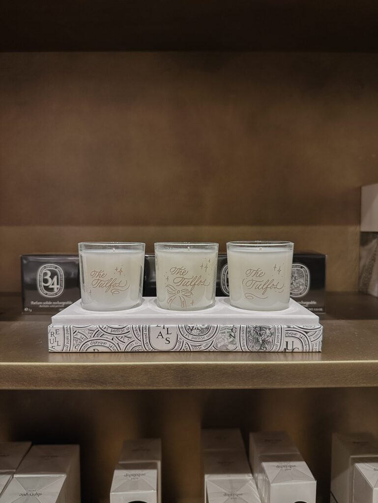 Family name engraved on three candles with embellishments.