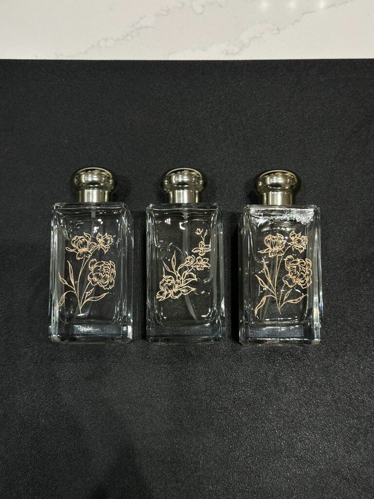 Perfume engraving with floral illustrations.