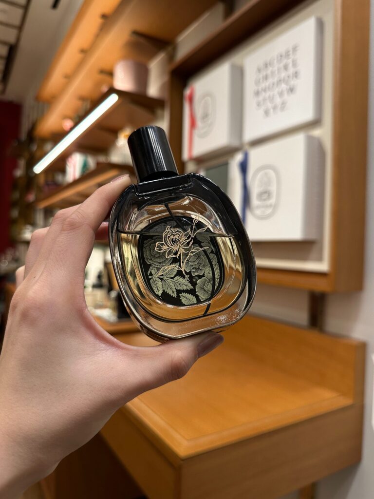 Floral engraving on Diptyque perfume.