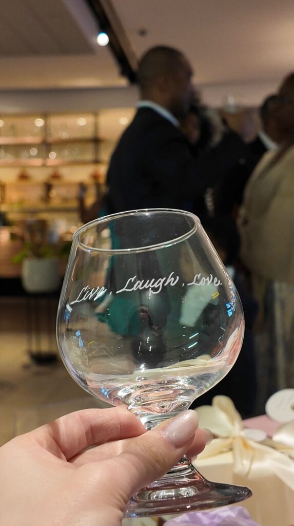 Close-up of engraved wine glass as custom wedding favors.