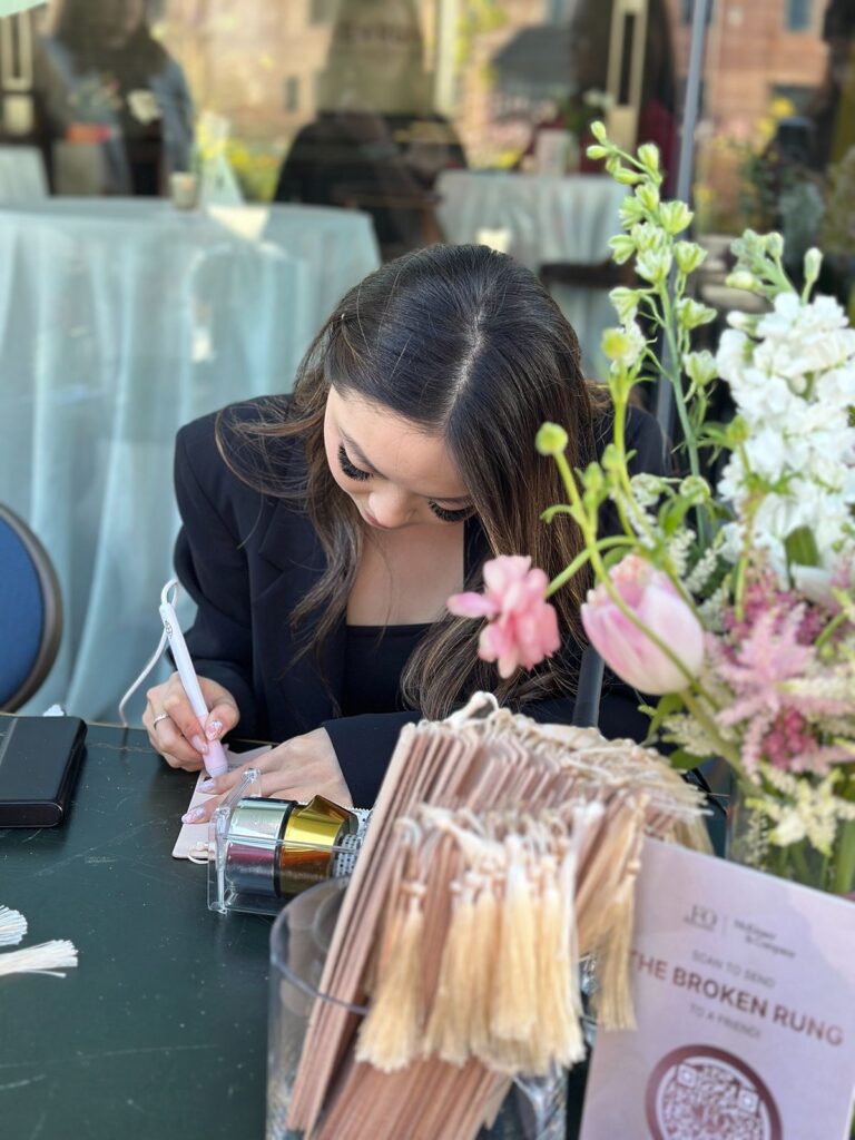 Live event calligrapher hot foiling on leather bookmarks.