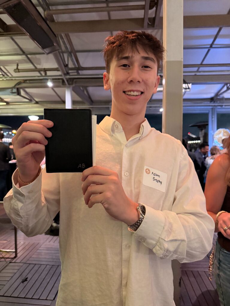 A guest with his leather passport cover embossed with gold initials.