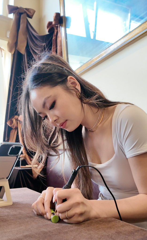 Live event artist hot-foil engraving a personalized name at the Sweet July launch.
